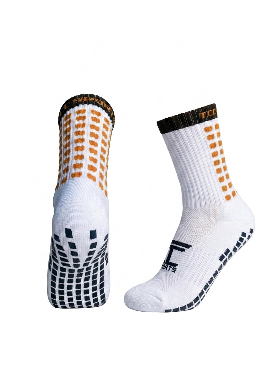 TCC Sports black and amber grip socks showing the side profile and silicone grip sole.
